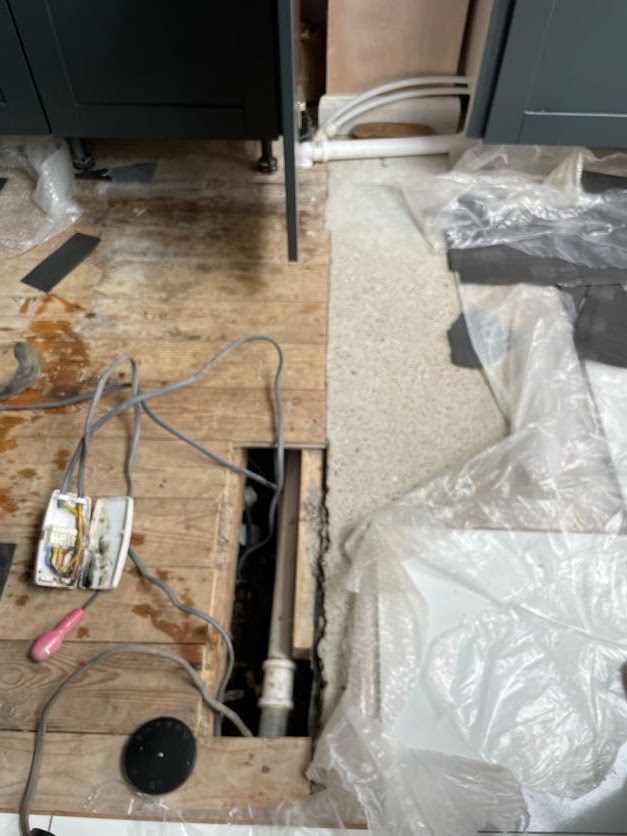 The kitchen floor opened up to expose the cables and the old junction box